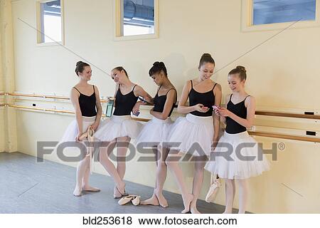 Girls talking and texting on cell phones in ballet studio View Large Photo Image Stock Photo - Girls talking and texting on cell phones in ballet studio. Fotosearch