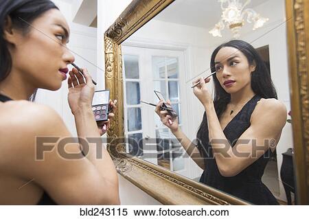 Glamorous transgender Thai woman applying eyeliner in mirror View Large Photo Image Stock Photography - Glamorous transgender Thai woman applying eyeliner in mirror. Fotosearch