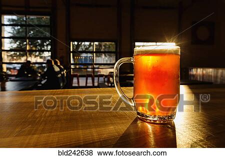 Glass of beer on counter View Large Photo Image Stock Photo - Glass of beer on counter. Fotosearch