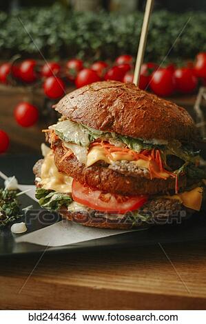 Picture - Gourmet cheeseburger on plate. Fotosearch