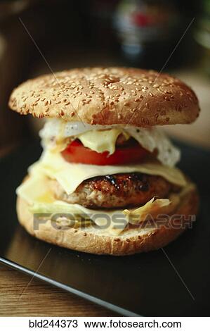 Stock Image - Gourmet cheeseburger on plate. Fotosearch