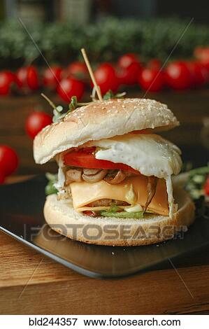 Gourmet cheeseburger on plate View Large Photo Image Stock Photo - Gourmet cheeseburger on plate. Fotosearch