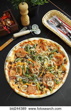 Gourmet pizza on plate View Large Photo Image Stock Photo - Gourmet pizza on plate. Fotosearch