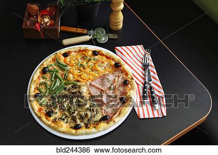 Gourmet pizza on plate View Large Photo Image Stock Photograph - Gourmet pizza on plate. Fotosearch