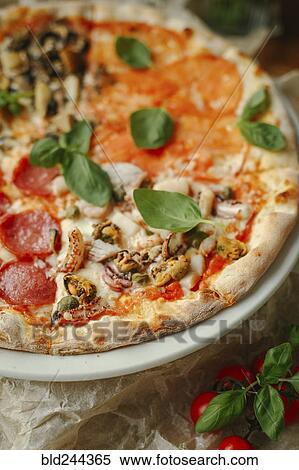 Gourmet pizza with basil and pepperoni View Large Photo Image Stock Photography - Gourmet pizza with basil and pepperoni. Fotosearch