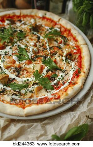 Gourmet pizza with basil on plate View Large Photo Image Stock Image - Gourmet pizza with basil on plate. Fotosearch