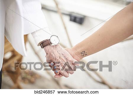 Grandmother and granddaughter holding hands View Large Photo Image Stock Photo - Grandmother and granddaughter holding hands. Fotosearch