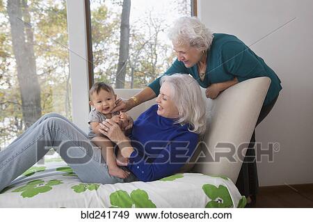 Grandmothers playing with baby grandson View Large Photo Image Stock Photo - Grandmothers playing with baby grandson. Fotosearch
