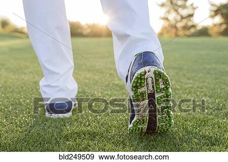 Stock Photo - Grass sticking to shoe of golfer. Fotosearch