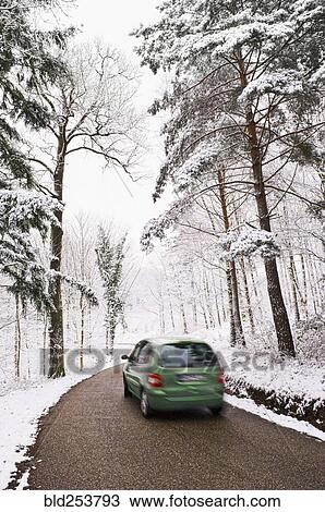 Green car driving on narrow road in winter View Large Photo Image Stock Image - Green car driving on narrow road in winter. Fotosearch