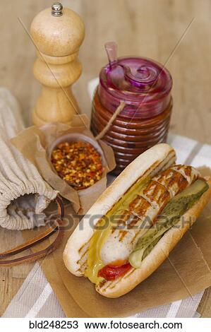 Stock Image - Grilled sausage in bun. Fotosearch