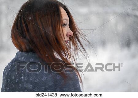 Stock Photo - Hair of Caucasian woman blowing in wind in winter. Fotosearch