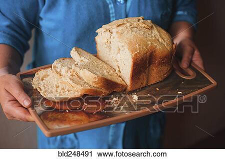 Hands holding tray of sliced bread View Large Photo Image Stock Image - Hands holding tray of sliced bread. Fotosearch