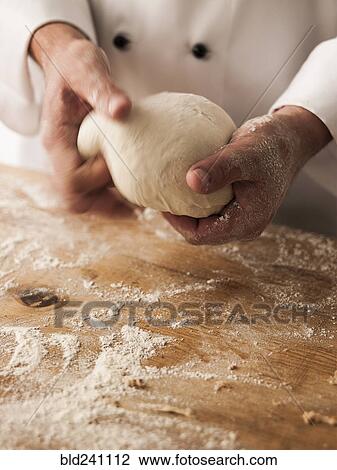 Hands of baker kneading dough View Large Photo Image Stock Image - Hands of baker kneading dough. Fotosearch