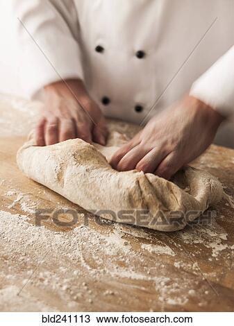 Hands of baker kneading dough View Large Photo Image Stock Image - Hands of baker kneading dough. Fotosearch