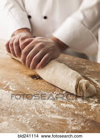 Hands of baker rolling dough View Large Photo Image Picture - Hands of baker rolling dough. Fotosearch