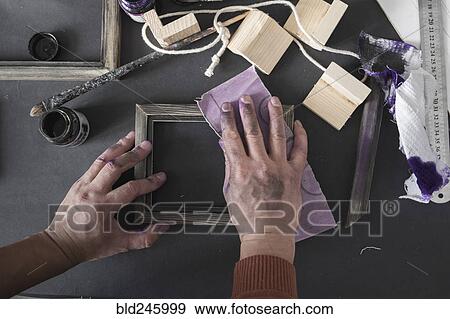 Hands of Caucasian artist sanding picture frame View Large Photo Image Stock Photo - Hands of Caucasian artist sanding picture frame. Fotosearch