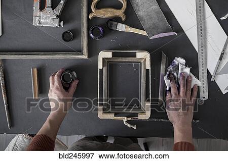 Hands of Caucasian artist staining picture frame View Large Photo Image Stock Photo - Hands of Caucasian artist staining picture frame. Fotosearch