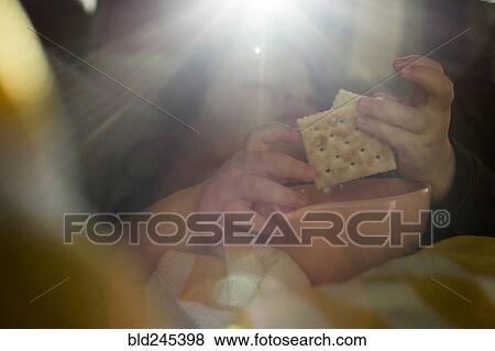 Hands of Caucasian girl eating crackers View Large Photo Image Stock Photo - Hands of Caucasian girl eating crackers. Fotosearch