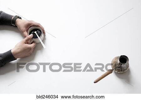 Picture - Hands of Caucasian man holding coffee cup. Fotosearch