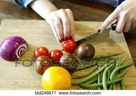 Stock Image - Hands of woman chopping vegetables. Fotosearch