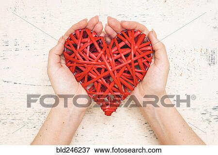 Stock Photo - Hands of woman holding handmade valentine. Fotosearch