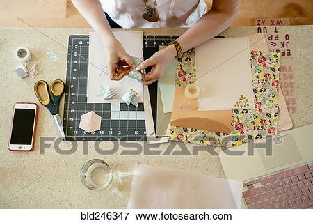 Stock Photo - Hands of woman making bow on table. Fotosearch