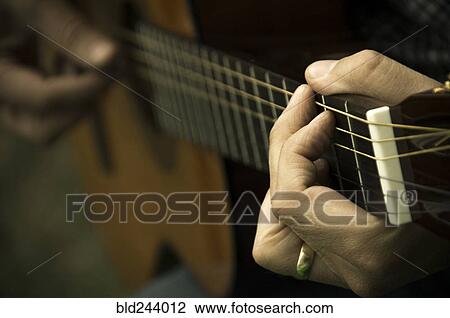 Hands on man playing guitar View Large Photo Image Stock Image - Hands on man playing guitar. Fotosearch