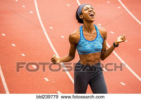 Happy Black athlete celebrating on track View Large Photo Image Stock Photo - Happy Black athlete celebrating on track. Fotosearch