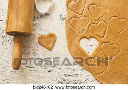 Stock Image - Heart shape cut from cookie dough. Fotosearch