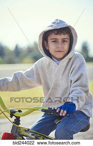 Hispanic boy posing on bicycle View Large Photo Image Stock Image - Hispanic boy posing on bicycle. Fotosearch