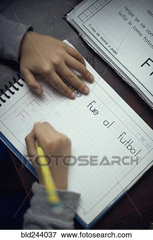 Stock Photo - Hispanic boy practicing writing alphabet. Fotosearch