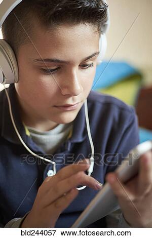 Hispanic boy using digital tablet and headphones View Large Photo Image Stock Photo - Hispanic boy using digital tablet and headphones. Fotosearch