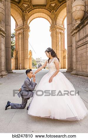 Hispanic boy wearing suit kissing hand of girl wearing gown View Large Photo Image Stock Image - Hispanic boy wearing suit kissing hand of girl wearing gown. Fotosearch