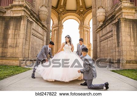Hispanic boys holding skirt of girl View Large Photo Image Stock Image - Hispanic boys holding skirt of girl. Fotosearch