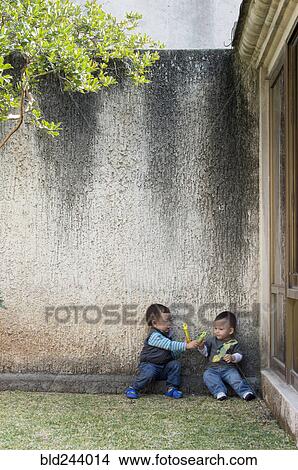 Picture - Hispanic boys playing in yard. Fotosearch