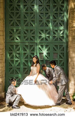 Hispanic boys wearing suits holding skirt of girl View Large Photo Image Stock Image - Hispanic boys wearing suits holding skirt of girl. Fotosearch