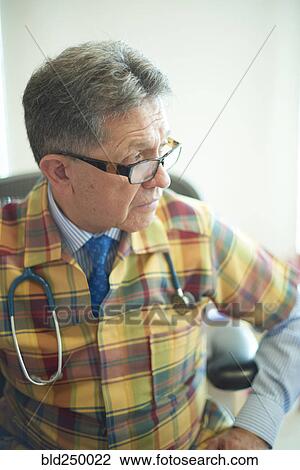 Stock Image - Hispanic doctor looking away. Fotosearch