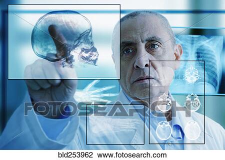 Stock Image - Hispanic doctor using virtual computer screen. Fotosearch
