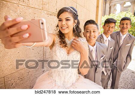 Hispanic girl and boys posing for cell phone selfie View Large Photo Image Stock Photo - Hispanic girl and boys posing for cell phone selfie. Fotosearch