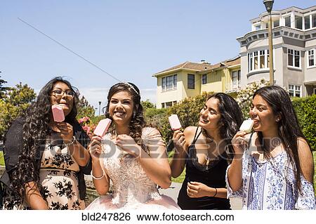 Hispanic girls eating popsicles View Large Photo Image Stock Photograph - Hispanic girls eating popsicles. Fotosearch