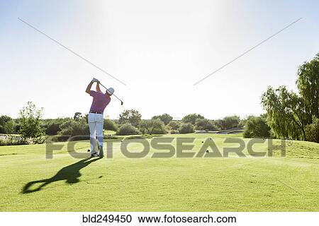 Hispanic golfer teeing off on golf course View Large Photo Image Stock Image - Hispanic golfer teeing off on golf course. Fotosearch