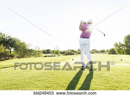 Hispanic golfer teeing off on golf course View Large Photo Image Stock Image - Hispanic golfer teeing off on golf course. Fotosearch