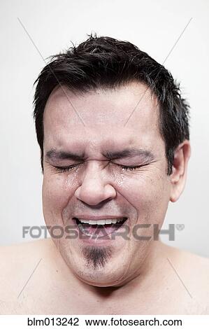Stock Image - Hispanic man crying. Fotosearch