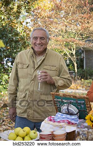 Hispanic man drinking wine outdoors View Large Photo Image Stock Image - Hispanic man drinking wine outdoors. Fotosearch