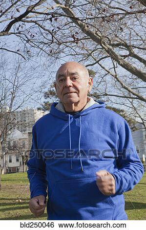 Hispanic man jogging in park View Large Photo Image Stock Photograph - Hispanic man jogging in park. Fotosearch