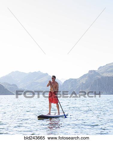 Hispanic man on paddleboard in river View Large Photo Image Stock Photography - Hispanic man on paddleboard in river. Fotosearch