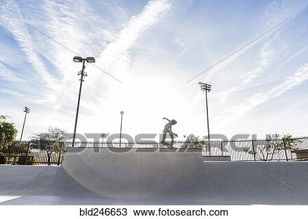 Hispanic man riding skateboard at skate park View Large Photo Image Stock Image - Hispanic man riding skateboard at skate park. Fotosearch