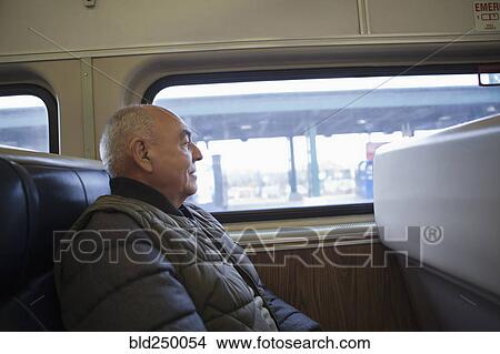 Hispanic man sitting on train View Large Photo Image Picture - Hispanic man sitting on train. Fotosearch
