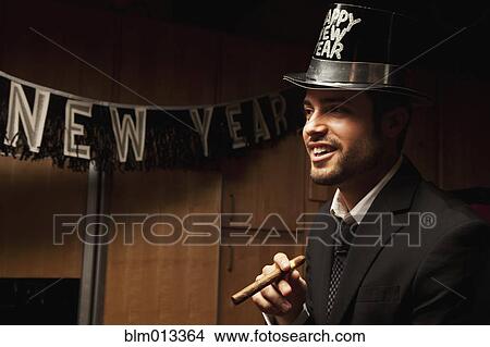 Picture - Hispanic man wearing hat for New Year's Eve. Fotosearch